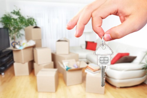 Soho flat removals with moving team carrying boxes through a narrow central London street