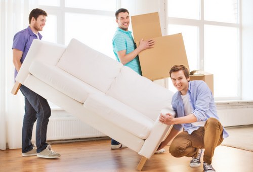 Removals team working in a Soho street with boxes and furniture