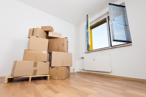 Packed moving boxes ready for a home move in Soho street surroundings