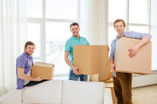 Moving staff handling boxes with care and using safe lifting practices